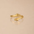 Adjustable Hug Hands Ring, Steel — Embrace — Gold-tone hug ring on neutral background