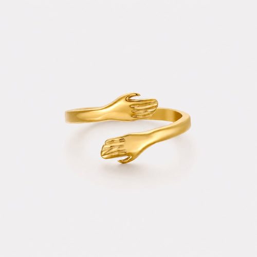 Adjustable Hug Hands Ring, Steel — Embrace — Gold-tone open ring with two sculpted hands